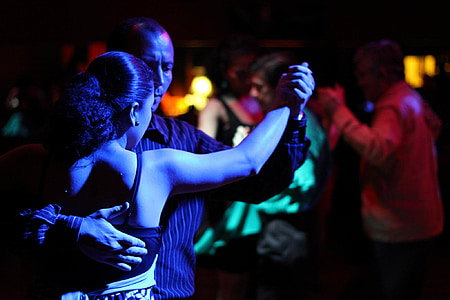 man and woman dancing under disco light