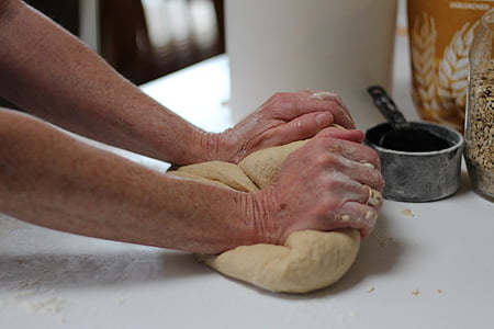 person making bread dough