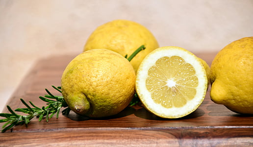 lemon on brown wooden table-top