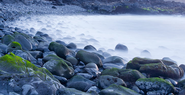 gray coastal rocks during daytime