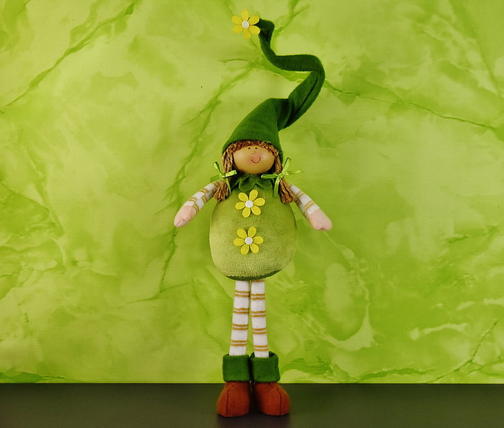 green and brown doll
