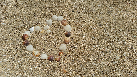 heart-shaped shell artwork in sand