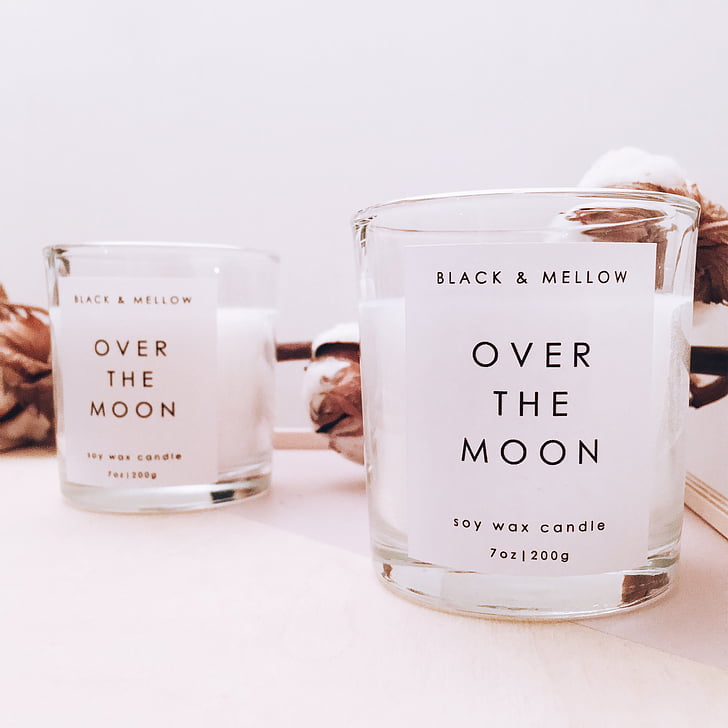selective focus photographyof two Over the Moon votive candles