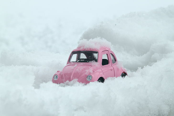 pink Volkswagen Beetle on snow land