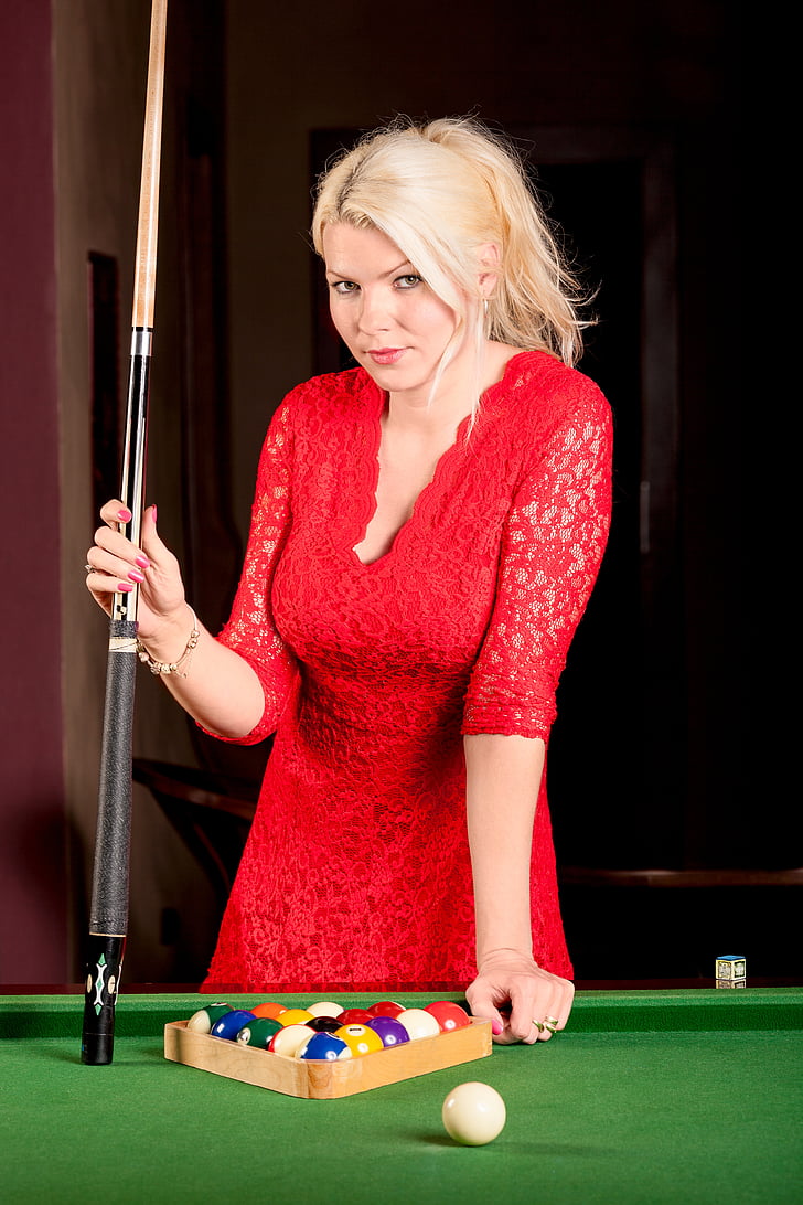 woman wearing red lace V-neck 3/4-sleeved dress holding cue stick