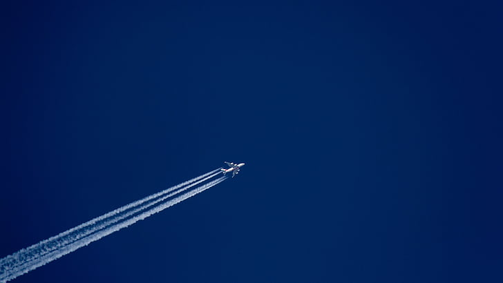 flying airplane in blue sky
