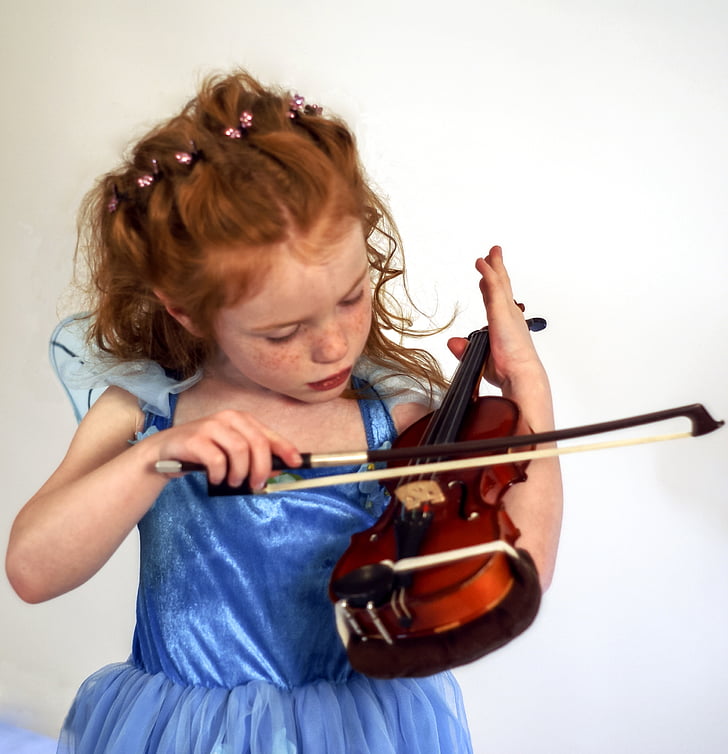 girl playing brown and black violin