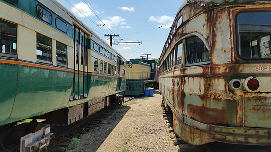 photo of two white-and-teal trains