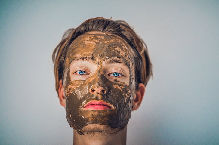 woman's face with mud mask
