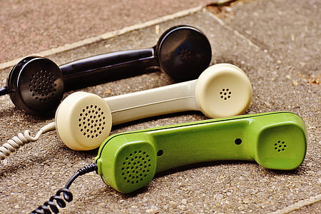 green, white, and black telephones
