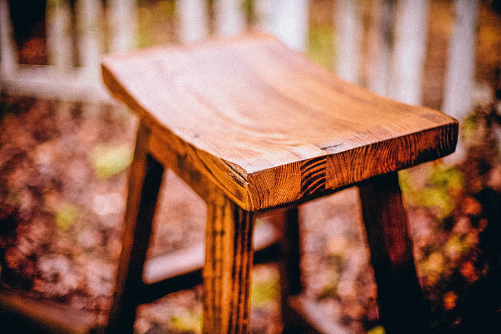 selective focus photography of brown bar stool