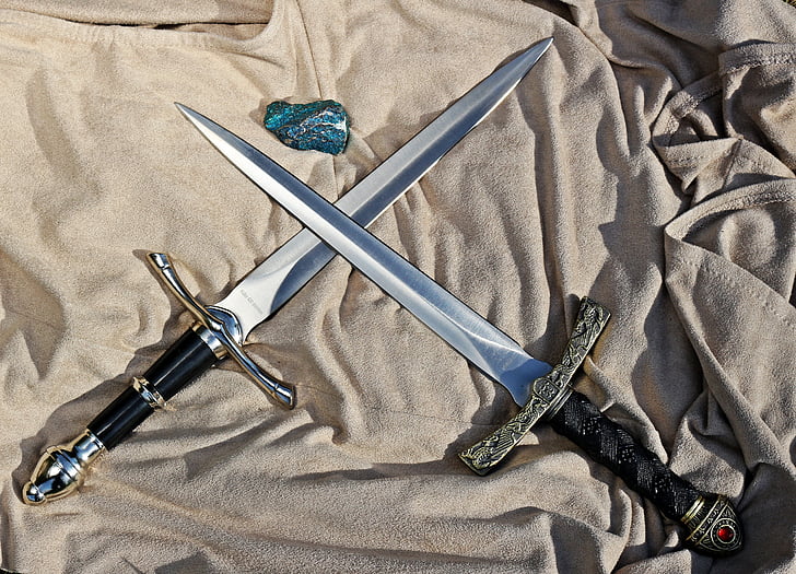 two silver swords with black handle
