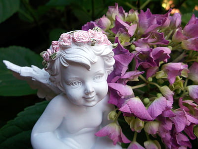 angel statue and purple flowers