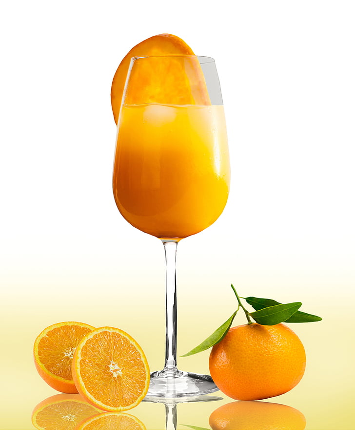 orange juice in clear goblet glass with orange slices