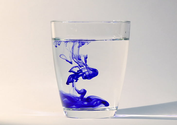 clear drinking glass with blue liquid