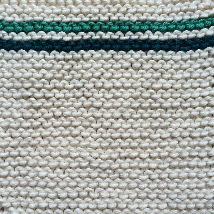 white and teal knit textile