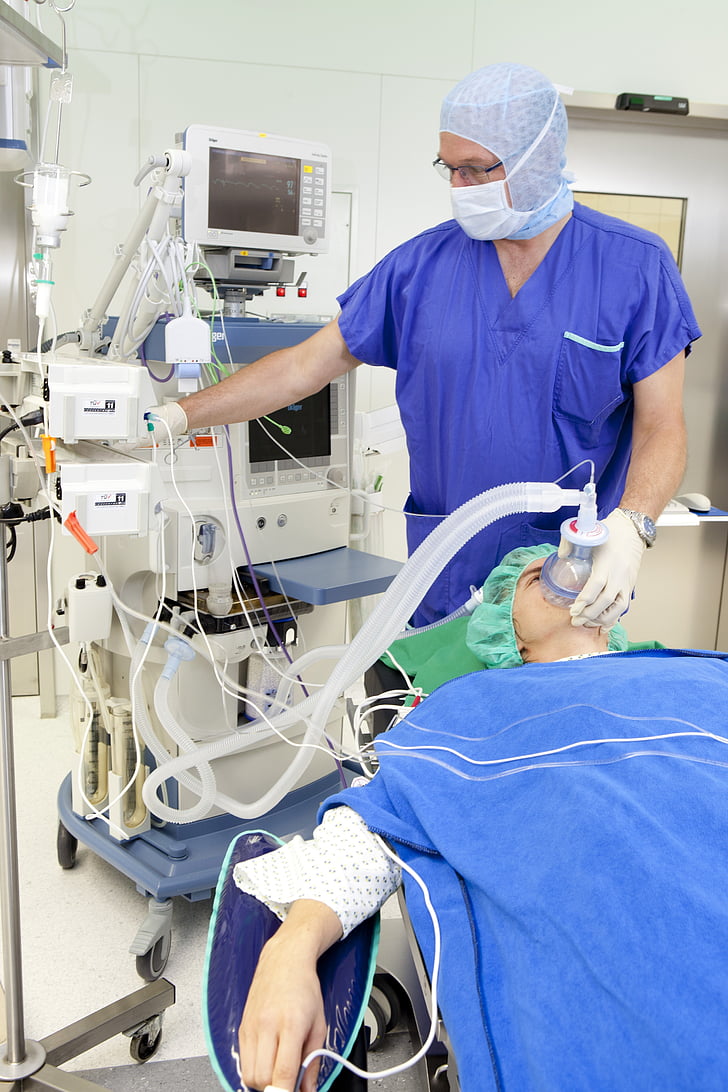 person using medical equipment on patient