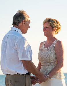 selective focus photography of man and woman standing holding hands during daytime