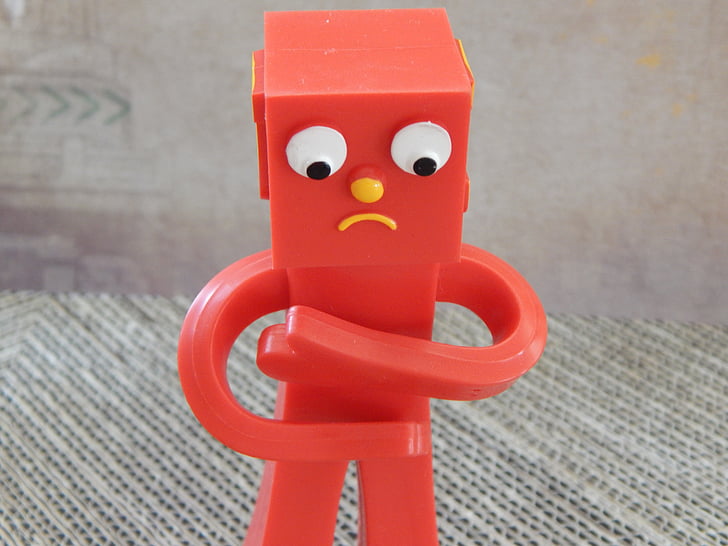 close-up photography of red toy robot