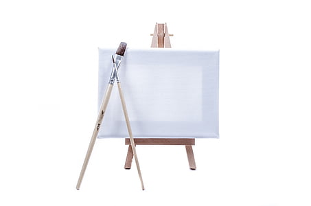 white paint canvass, easel, and two paintbrushes