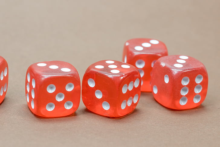 five red-and-white gaming dice on focus photo