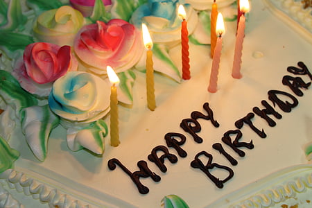 Happy Birthday cake with seven lighted candles