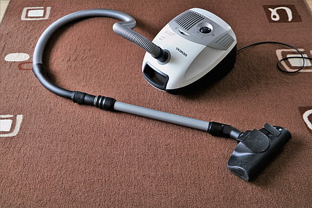 gray and white wet dry vacuum on brown area rug