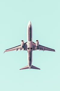 white passenger plane speeding in air at daytime