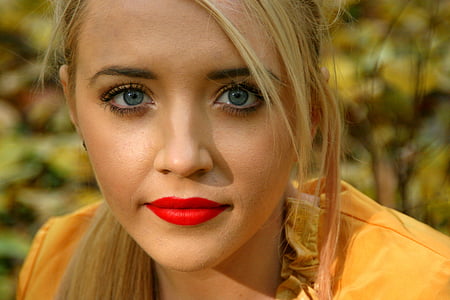 closeup photo of woman wearing orange top