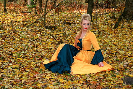 woman in yellow bindali dress sitting on the grass