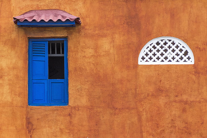 brown painted wall with blue window