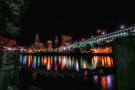 low-angle photo of bridge with view of city during nighttime