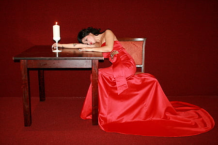 woman wearing red gown sitting on chair