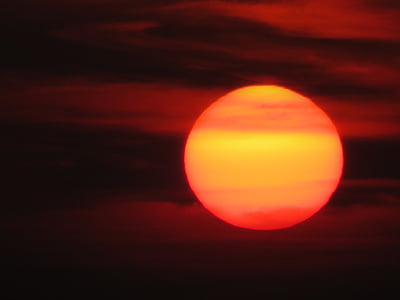 red sun covered by clcouds