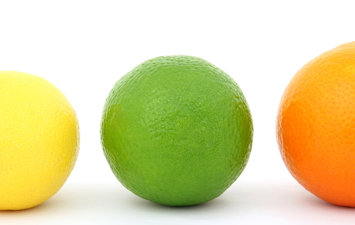 three round citrus fruits