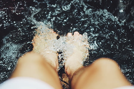 person's foot at the water