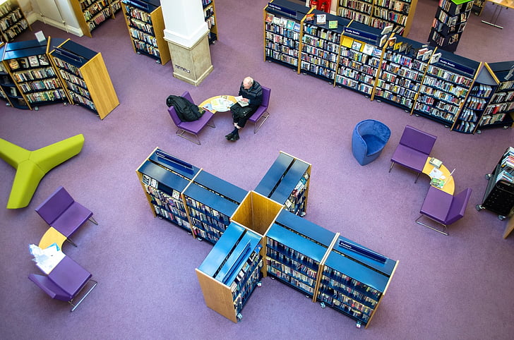 man sitting inside a library