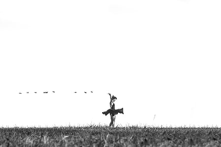 grayscale photo of woman on grass field
