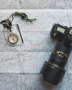 black Nikon DSLR camera on map