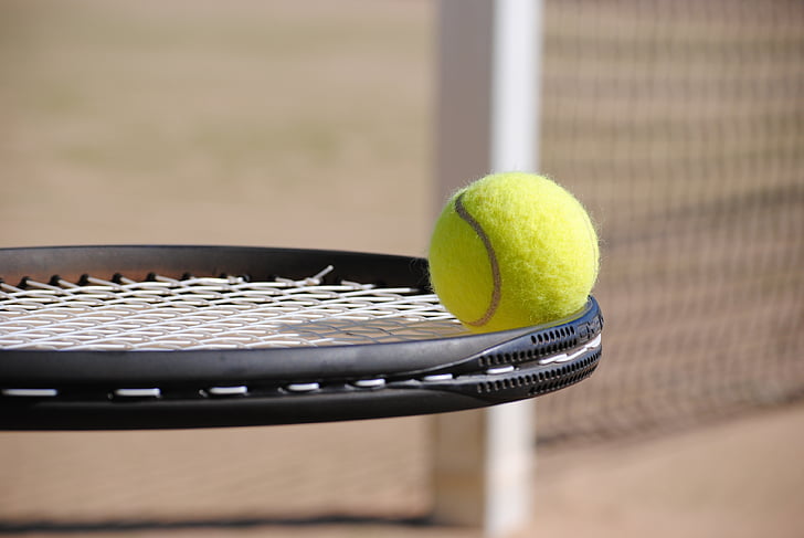 black tennis racket and tennis ball