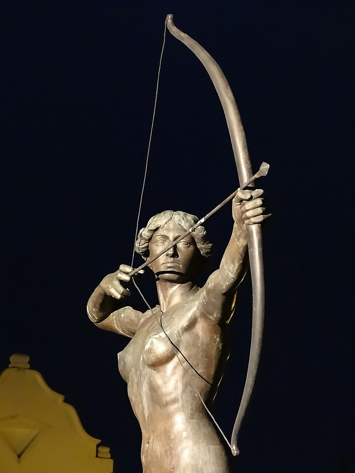 gray statue of man holding composite bow