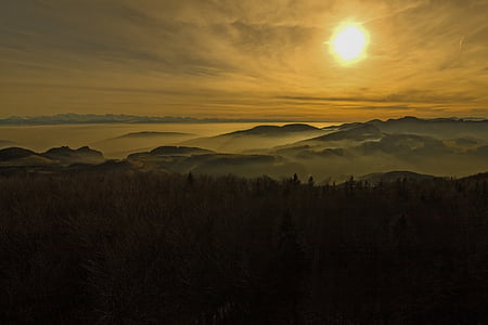 mountain with fog during sunrise