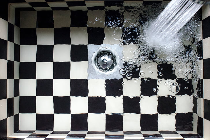 photography of checkered sink with water