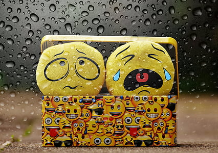 two yellow emoji plush toys