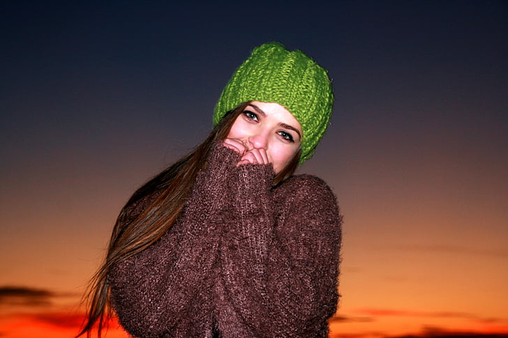 women's green knit cap under sunset