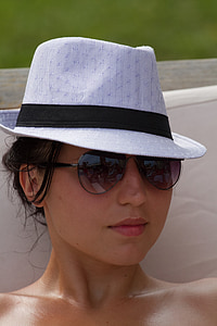 woman wearing sunglasses and Fedora hat