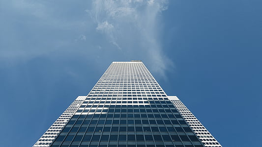 photo of white high-rise building under clear blue sky
