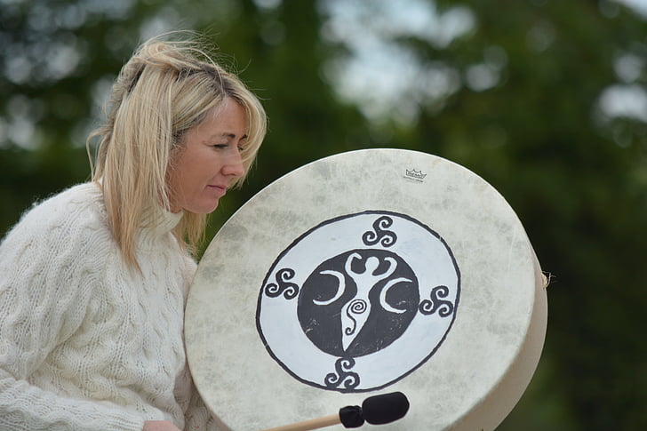 woman holding gong and stick