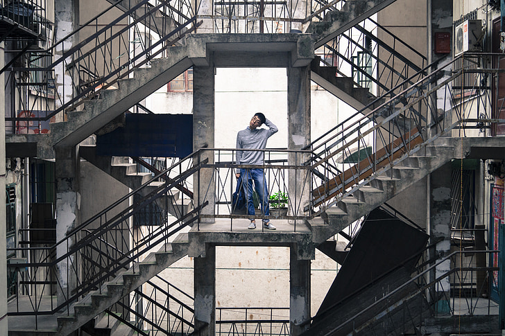 man standing on second floor of building