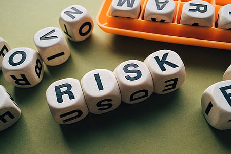 four white-and-black risk letter dices